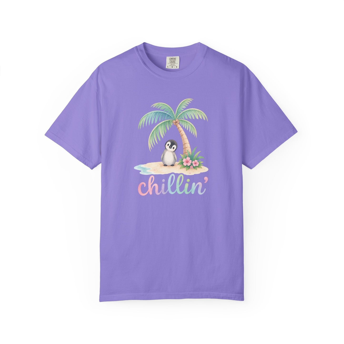 A light purple short-sleeve crewneck t-shirt featuring a tropical graphic of a penguin under a palm tree on a small beach with the word 'chillin'' written below in pastel letters, displayed on a clean white background.
