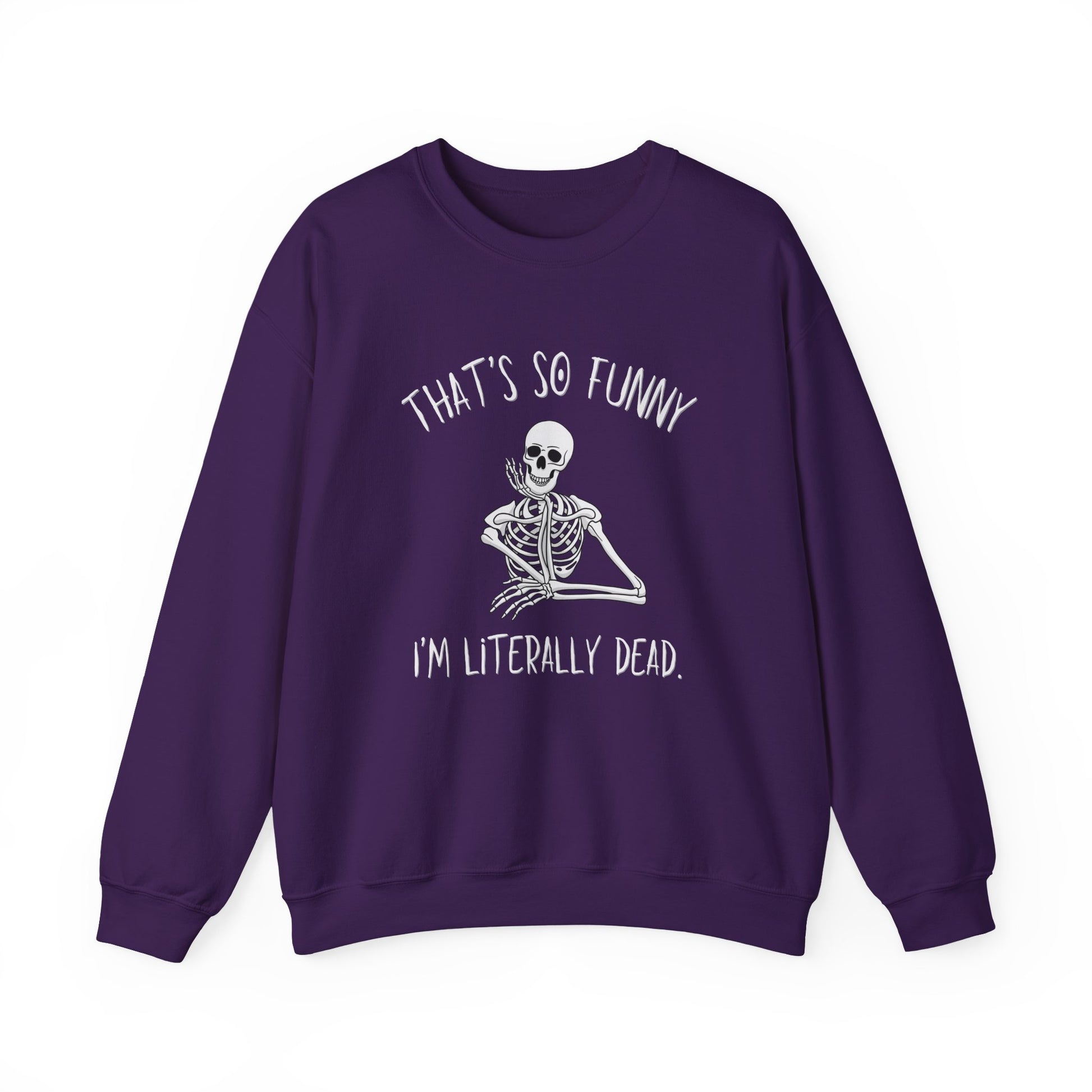 A purple crewneck sweatshirt featuring a white graphic of a skeleton sitting cross-legged with the text 'THAT'S SO FUNNY' above and 'I'M LITERALLY DEAD.' below, displayed on a clean white background.