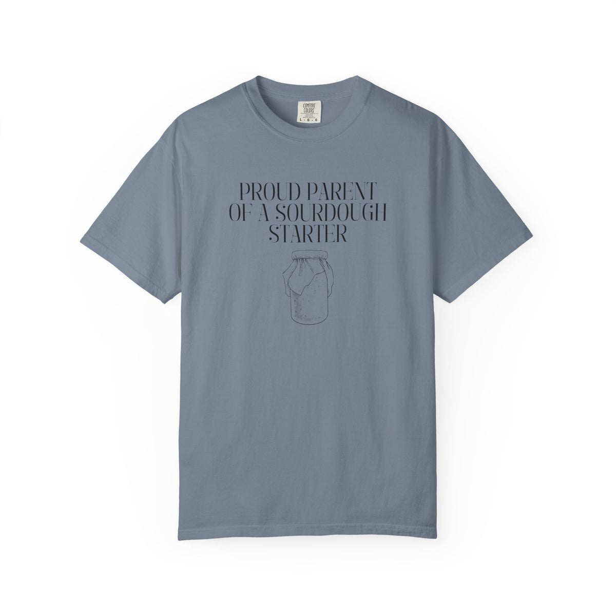 Blue jean Comfort Colors® "Proud Parent of a Sourdough Starter" graphic t-shirt on a white background with vintage sourdough starter jar illustration. Funny gift for sourdough bakers and bread enthusiasts.