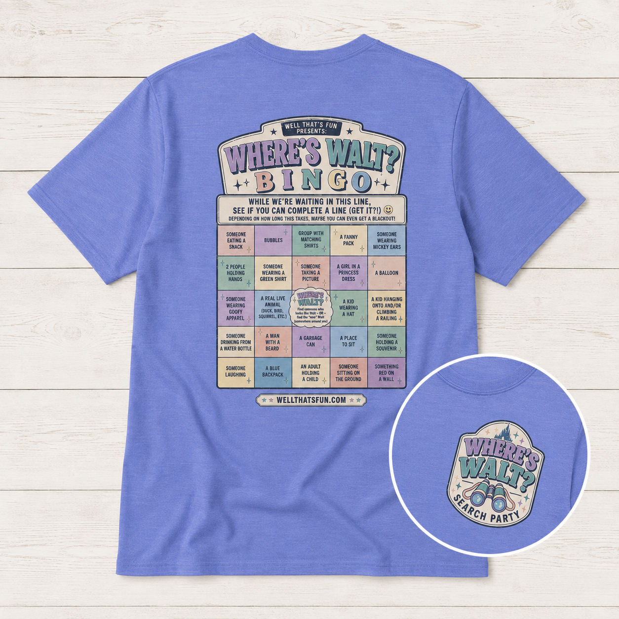 A light blue short-sleeve t-shirt shown from the back, featuring a colorful interactive 'Where's Walt?' bingo card graphic. A circular inset in the bottom right corner shows a close-up of the front print that says “where’s Walt search party.