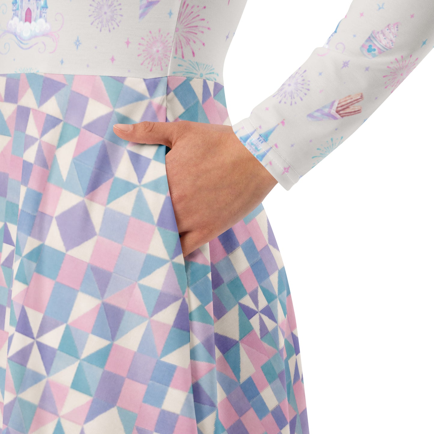 Close-up of a person wearing a long-sleeve dress with a pastel geometric quilt-like pattern with a hand tucked into the side pocket.