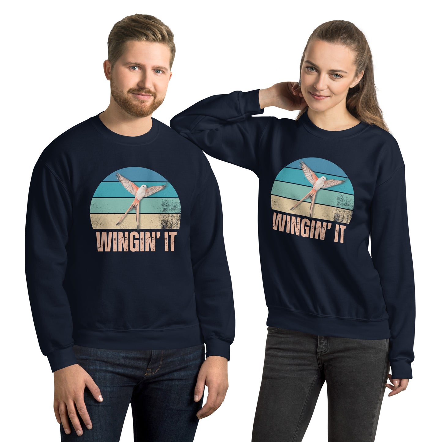 Boy and girl in matching navy blue Wingin' It crewneck sweatshirts with a Wingspan-inspired scissor-tailed flycatcher and colorful retro sunset design