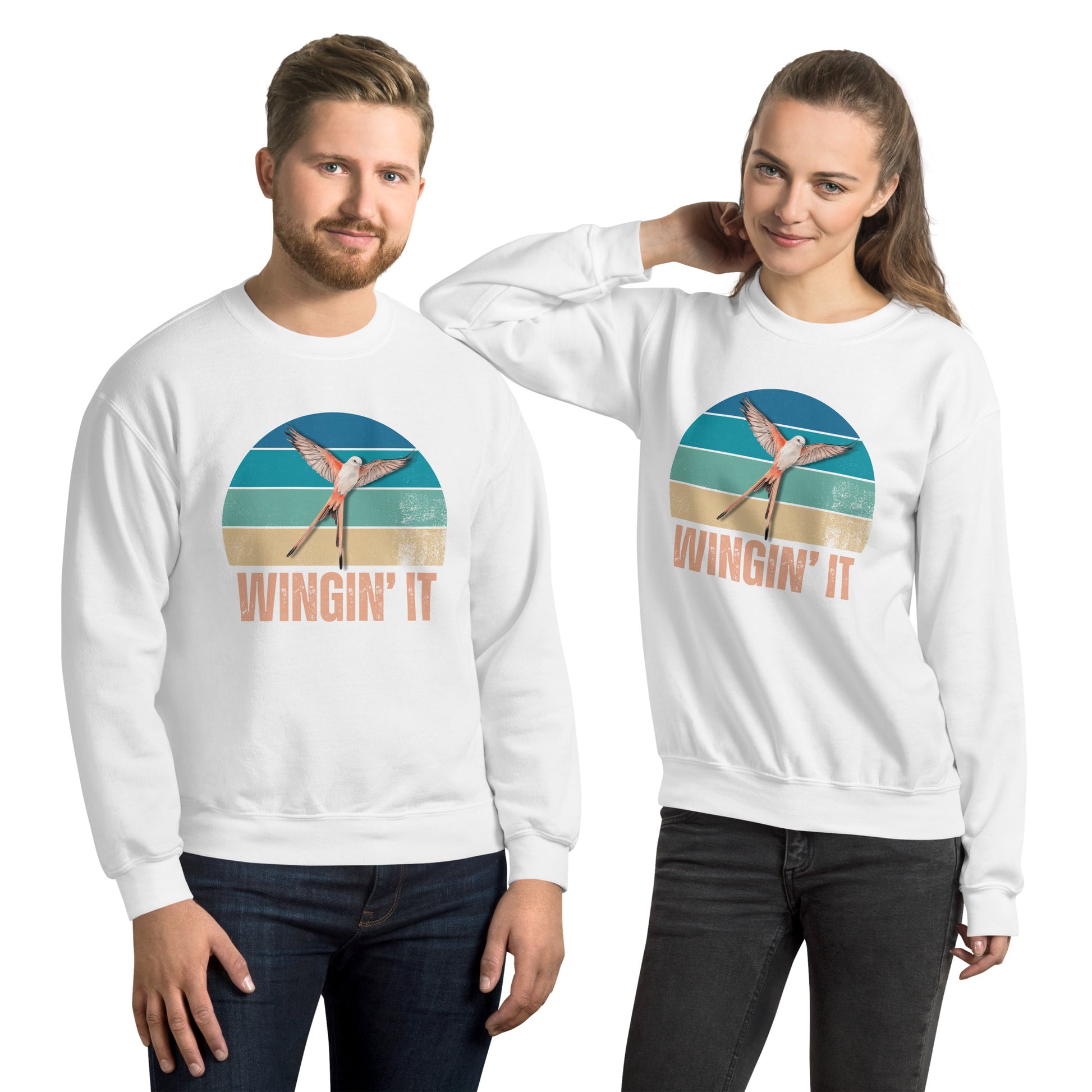 Man and Woman in white Wingin' It crewneck sweatshirts with a Wingspan-inspired scissor-tailed flycatcher and retro sunset design